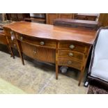 A George III satinwood banded mahogany serpentine sideboard with central tambour compartment width