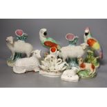 A group of Staffordshire animal and bird figures, to include a pair of sheep spill vases, two