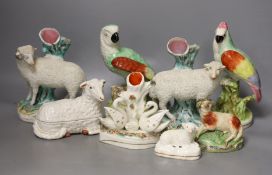 A group of Staffordshire animal and bird figures, to include a pair of sheep spill vases, two