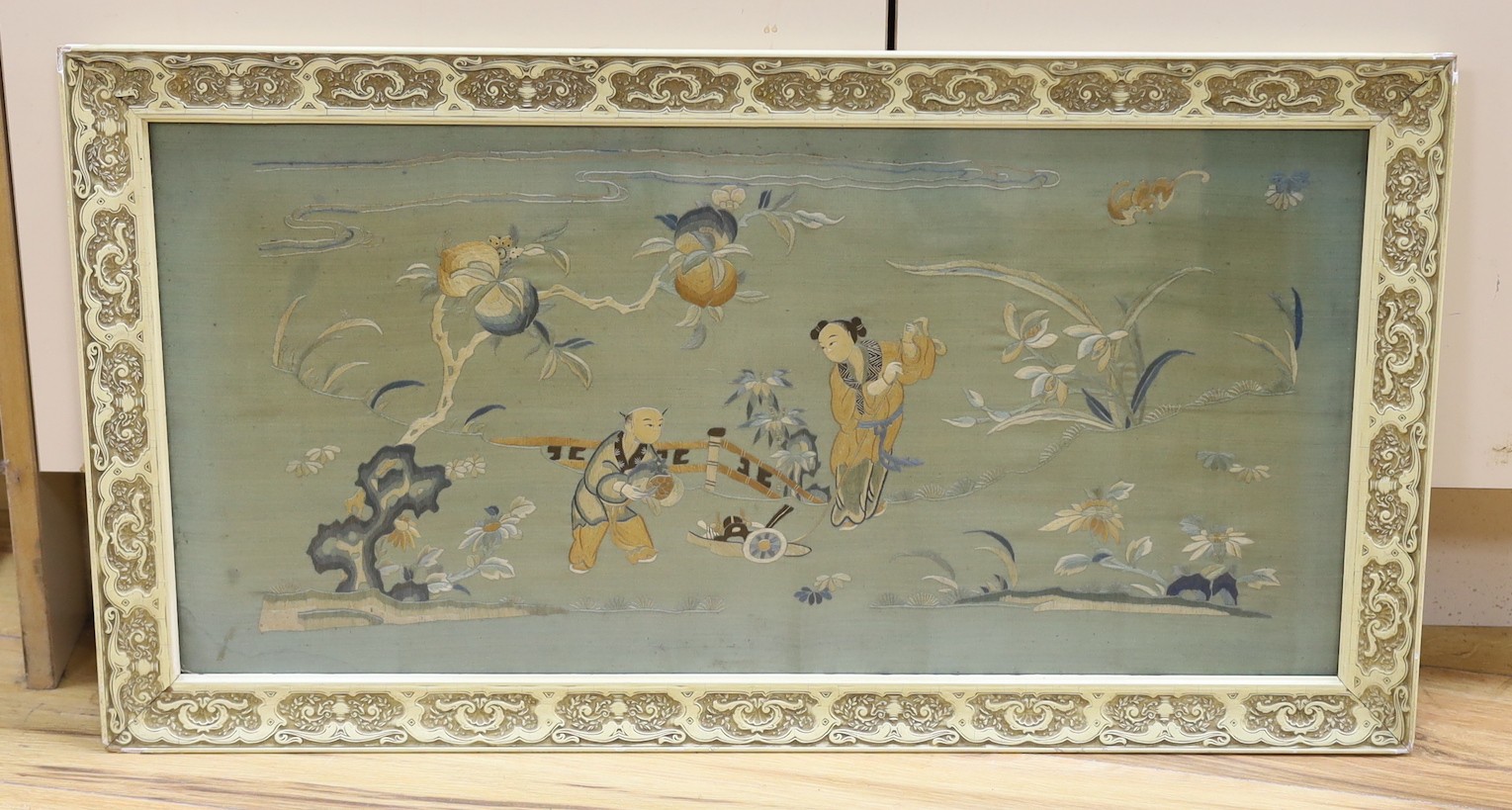 A 19th century framed Chinese polychrome silk embroidered panel,68 cms wide x 34 cms high.