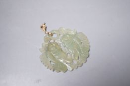 A Chinese carved bowenite jade ‘fish’ pendant,