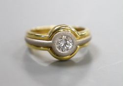 A modern 18ct two colour gold and solitaire diamond set ring, with sand blasted band, size L,