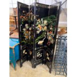 A Chinese black lacquer four fold dressing screen, each panel width 40cm, height 185cm