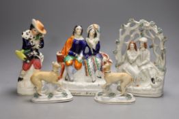 A pair of Victorian Staffordshire greyhounds and three Staffordshire pottery figures or groups -