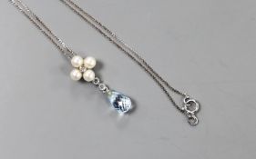 A modern 9k white metal, blue topaz, cultured pearl and diamond cluster set drop pendant, 23mm, on a