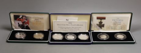 Cased Royal Mint UK silver proof coins – 2006 Victoria Cross two 50 pence, HM Queen silver jubilee