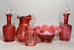 A pair of cranberry glass decanters, a jug, a fluted vase and a biscuit box and cover- decanters and