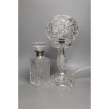 A cut glass globe table lamp and a similar silver collared decanter- lamp 41 cms high.