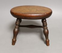 A 19th century walnut miniature stool, 12.5 cms high.
