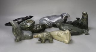 A collection of carved Canadian Inuit seal figures, largest 18 cm long (9)