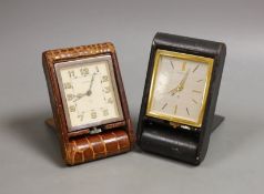 Two Jaeger travelling clocks with leather cases.
