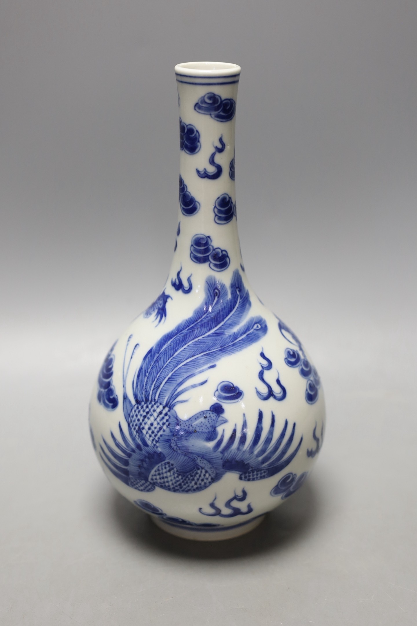 A Chinese blue and white ‘dragon and phoenix’ bottle vase, 23 cms high. - Image 2 of 3