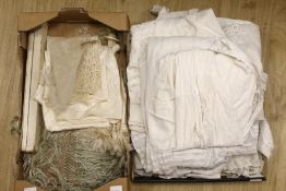 A collection of white worked christening gowns, a christening cape, a silk parasol, a lace bonnet