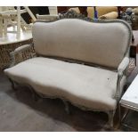 A 19th century French carved wood settee upholstered in a natural linen type fabric, re-painted in