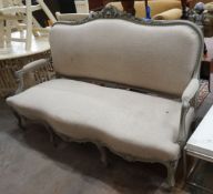 A 19th century French carved wood settee upholstered in a natural linen type fabric, re-painted in