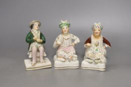 Two 19th-century Staffordshire porcellanous figures of seated Ottoman Turks and a seated figure of a