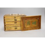 A Chinese bamboo and and bone mahjong set, 18 cms high x 25ms wide.