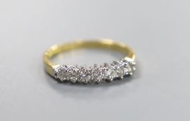 A modern 18ct gold and seven stone diamond set half hoop ring, size P/Q, gross weight 2.6 grams,