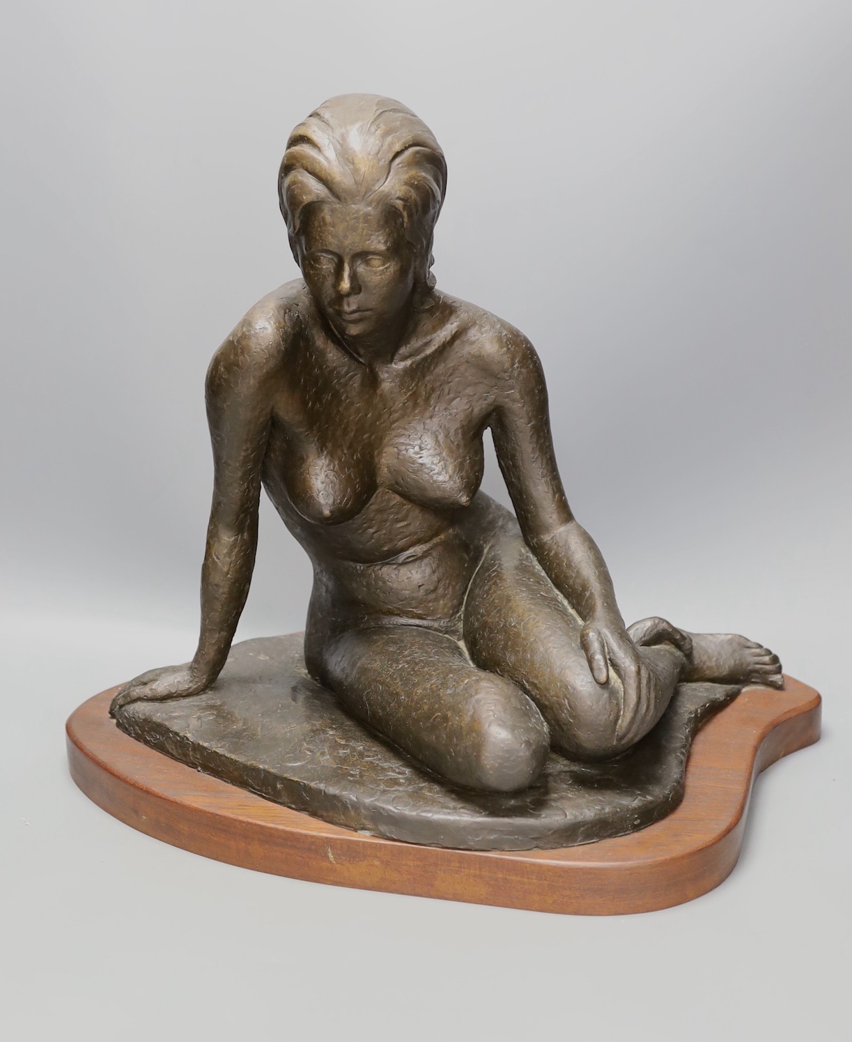 Audrey Shaw. A bronzed resin figure of a seated girl - 43cm tall