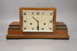 An Art Deco walnut mantel clock, 38 cms wide.