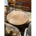 An Arts & Crafts style circular oak table, diameter 110cm, height 73cm and two chairs