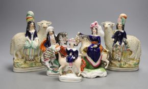 A pair of 19th century Staffordshire sheep and children groups and three Staffordshire pottery and