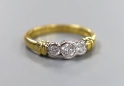 A modern 18ct gold and collet set three stone diamond ring, size O, gross weight 4.6 grams, total