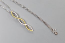 A modern two colour 18ct gold and two colour diamond set overlapping pendant, 42mm, on an 18ct white
