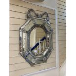 A Venetian octagonal engraved wall mirror with floral scroll pediment and bevelled central plate,