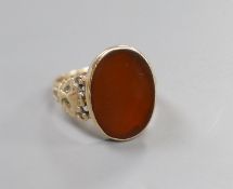A 1970's Victorian style 9ct gold and carnelian set oval signet ring, with carved shoulders, size T,