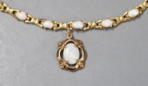 A modern 585 yellow metal and fourteen stone opal set drop bracelet, 19.3cm, gross weight 10.7