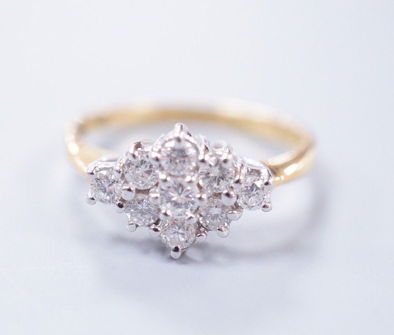 A modern 18ct gold and nine stone diamond set shaped cluster ring, size P, gross weight 4.3 grams,
