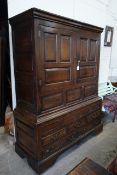An 18th century panelled oak press cupboard, width 140cm, depth 56cm, height 185cm**CONDITION