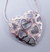 A modern 9k white metal and diamond chip set open work heart pendant, 26mm, on a 9ct white gold fine