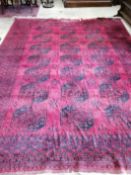 An Afghan red ground carpet (a.f.), 370 x 278cm**CONDITION REPORT**PLEASE NOTE:- Prospective