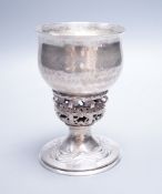 An Edwardian Arts & Crafts planished silver chalice, by Ramsden & Carr, inscribed ' I was wrought