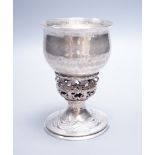 An Edwardian Arts & Crafts planished silver chalice, by Ramsden & Carr, inscribed ' I was wrought