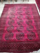 An Afghan red ground carpet, 276 x 200cm**CONDITION REPORT**PLEASE NOTE:- Prospective buyers are
