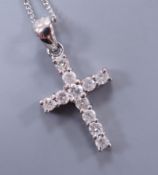 A modern 18ct white gold and diamond cluster set cross pendant, overall 24mm, on an 18ct white