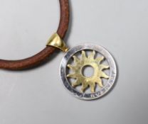 A modern Bulgari 18k and steel circular 'sun' pendant, 30mm, on a Bulgari fabric necklet, with 750