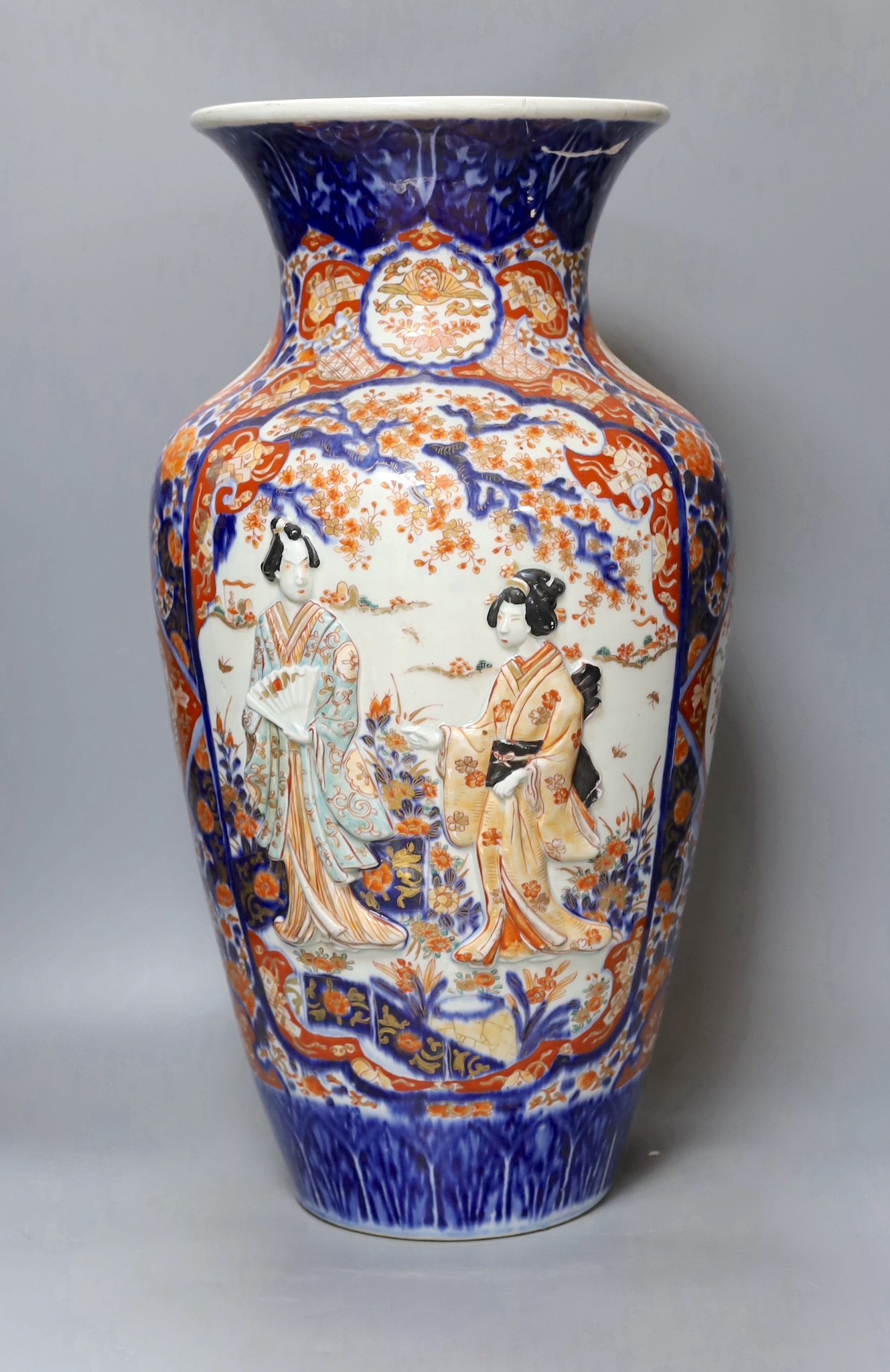 An unusual large Japanese Imari vase, Meiji period relief moulded with figures, 57cm tall,