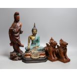 A Chinese carved wood figure of Guanyin, a pair of Buddhist lions and a cast brass figure of Buddha,