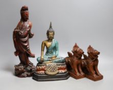 A Chinese carved wood figure of Guanyin, a pair of Buddhist lions and a cast brass figure of Buddha,
