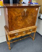 An early 18th century banded walnut fall front secretaire, the interior fitted with numerous
