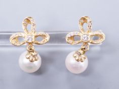 A modern pair of 18k yellow metal, cultured pearl and diamond cluster set drop earrings, 21mm, gross