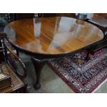 A 1920's mahogany extending dining table on ball and claw feet, with three spare leaves, 296cm