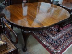 A 1920's mahogany extending dining table on ball and claw feet, with three spare leaves, 296cm