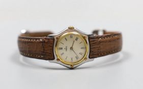 A lady's 18K and steel Ebel 1911 quartz wrist watch, on a leather strap with steel deployment clasp,