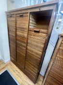 A mid century oak triple tambour filing cabinet, width 129cm depth 37cm height 180cm**CONDITION
