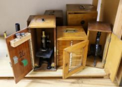 Five cased microscopes, another uncased and a pine microscope slide cabinet, latter 25.5 cm